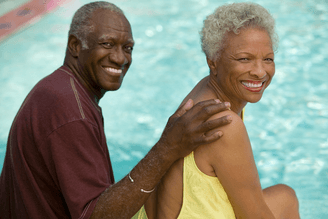 a happy black senior couple smining