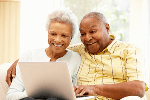 a senior couple on a laptop getting into online dating